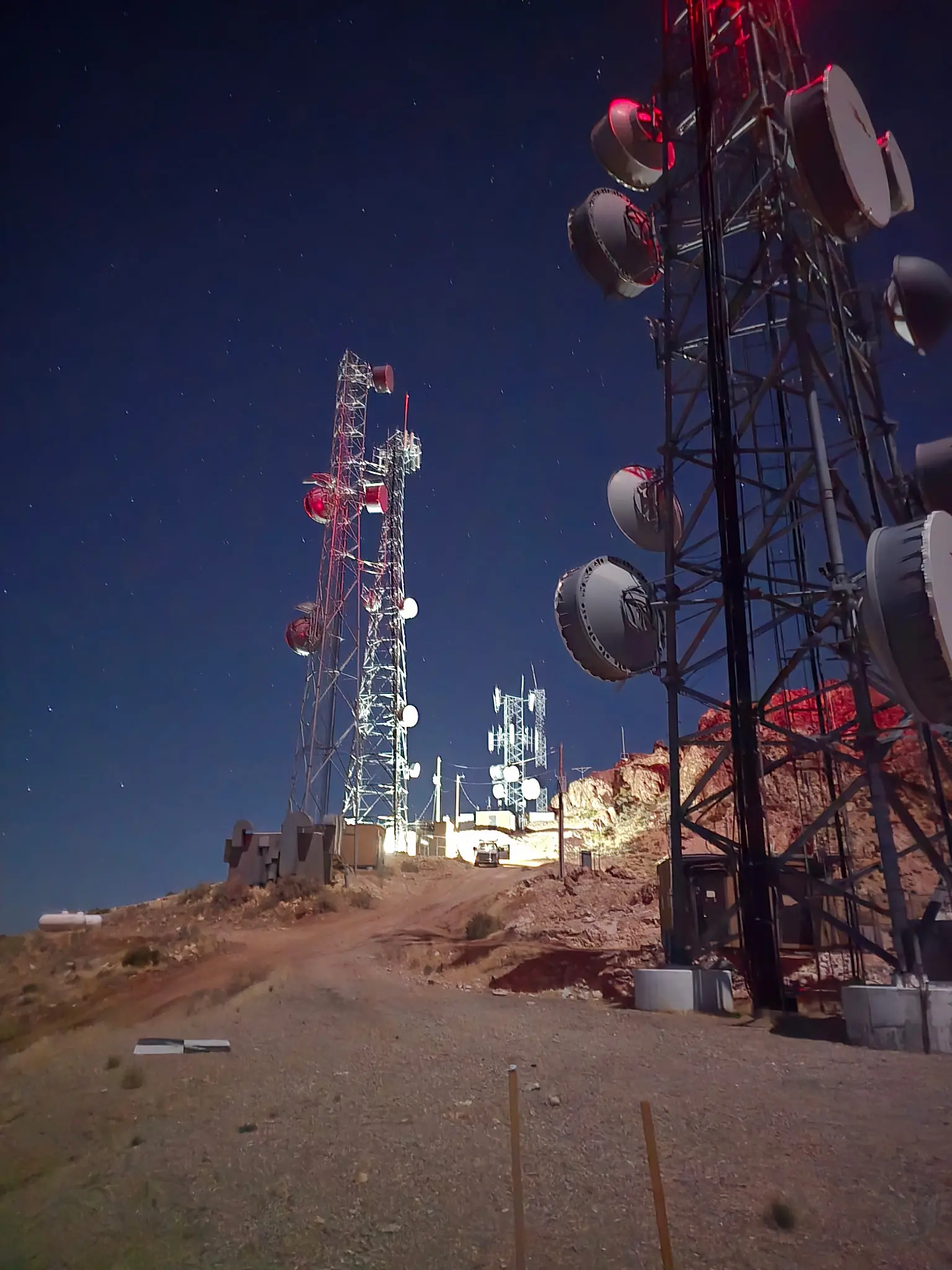 1000008871 A view of some towers and antennas on top of a hill.